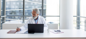 a doctor at his workstation