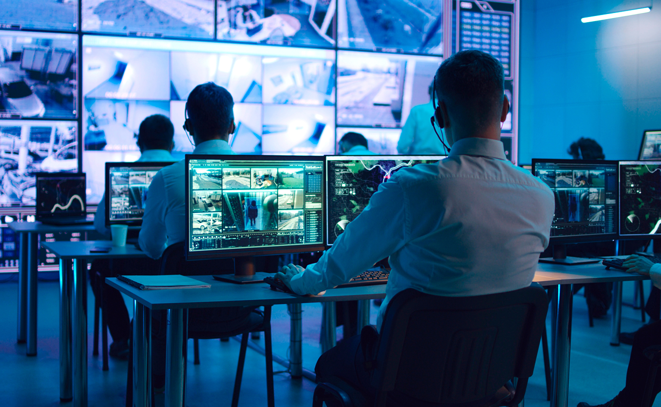 Security operations team monitoring cyber threats across multiple screens.