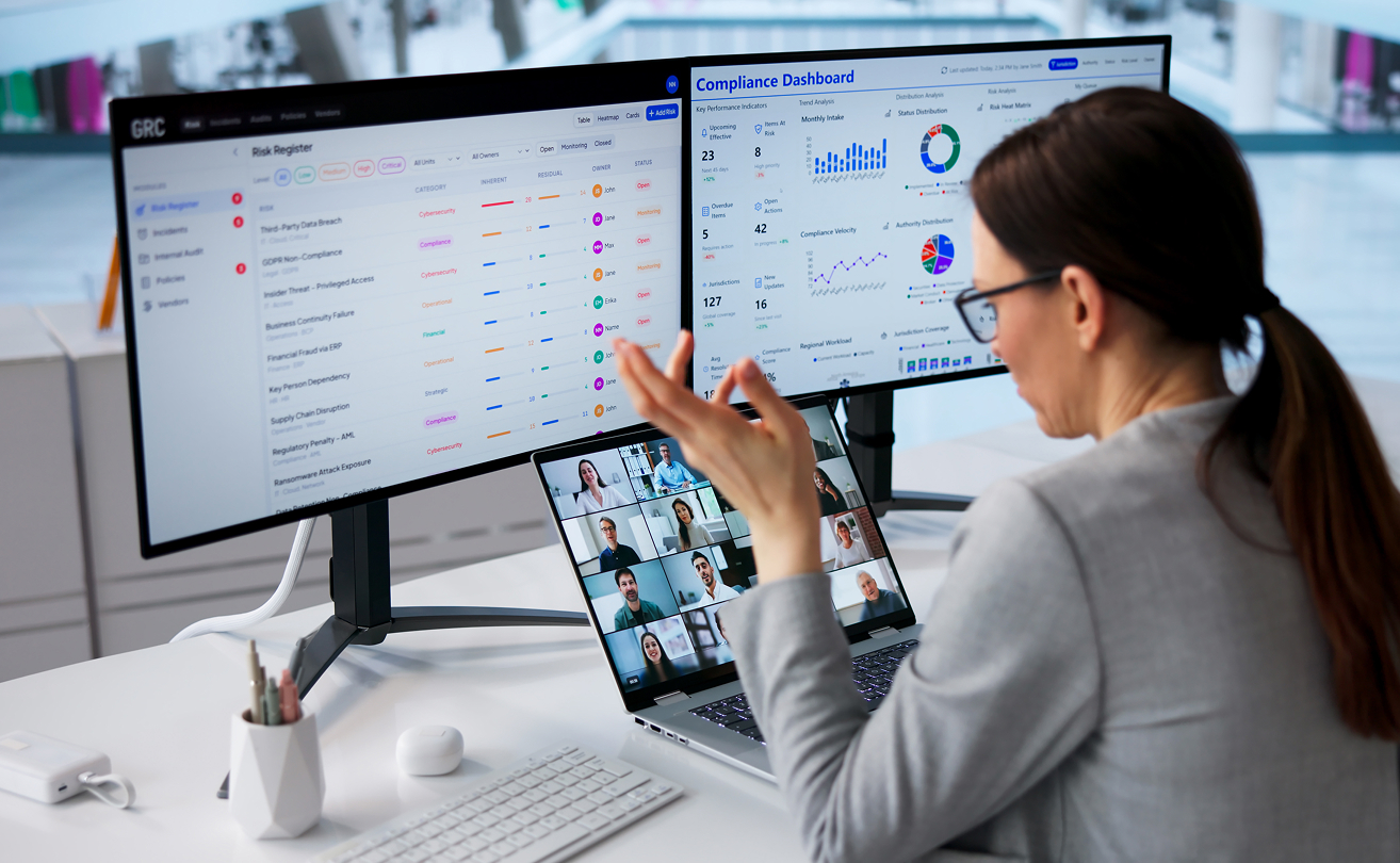 IT professional analyzing performance dashboards on dual monitors.