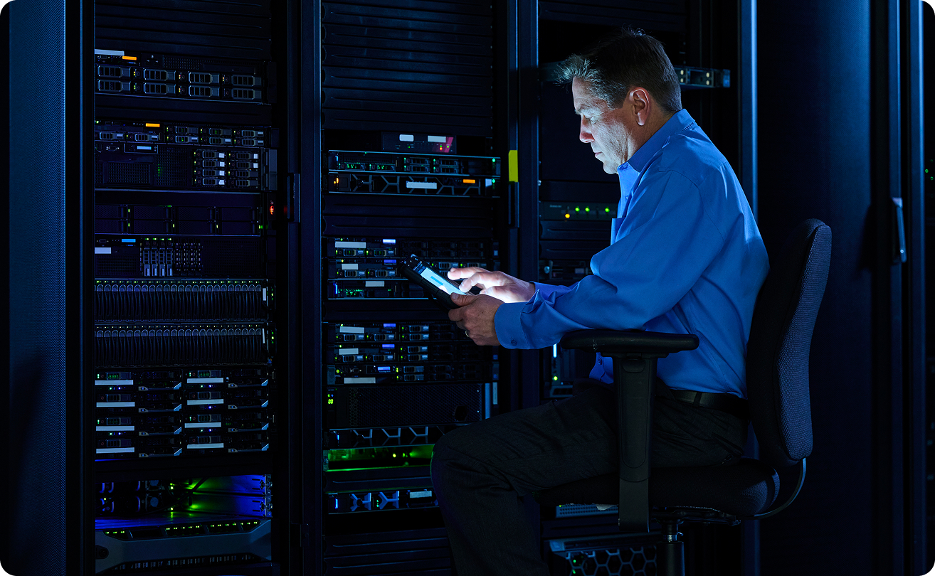 IT administrator managing servers in a data center using a tablet.
