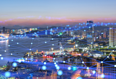 Cityscape at dusk with digital network overlay