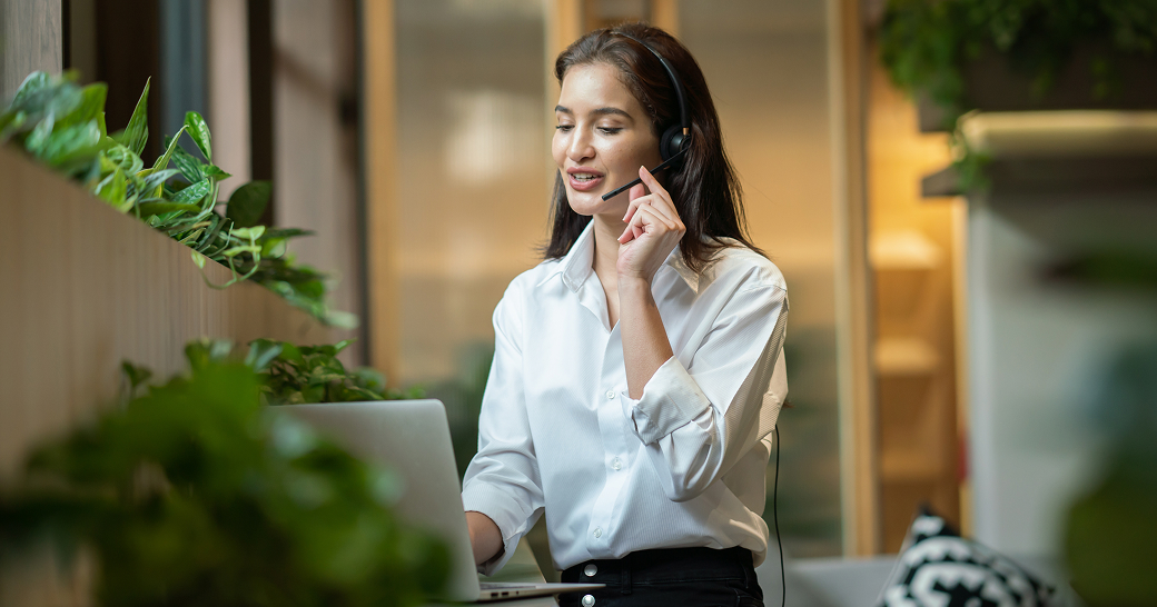 Business professional managing work tasks across digital tools in a modern office.