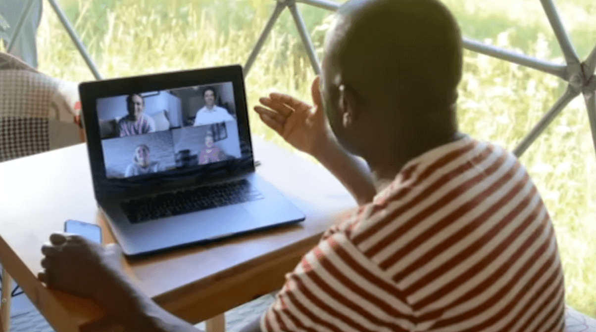 Person in a remote location in an online meeting on their laptop