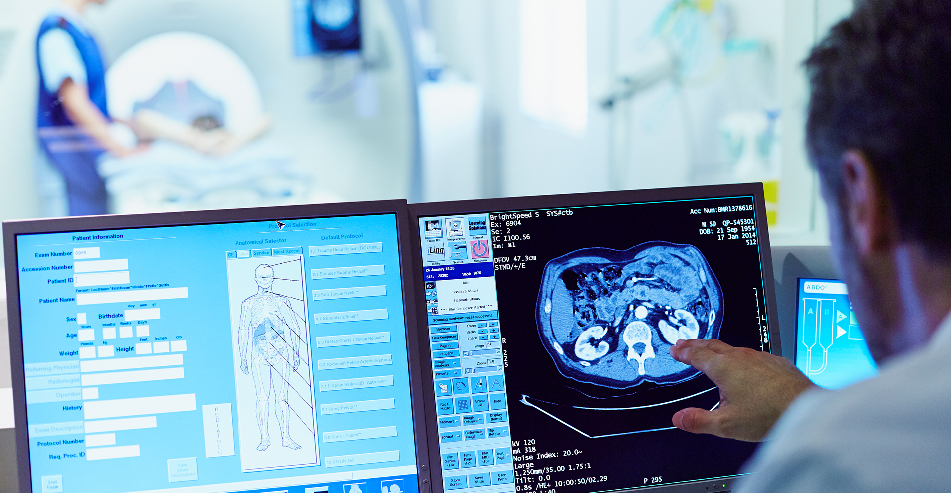 Healthcare professional viewing patient imaging and clinical data on multiple digital screens.