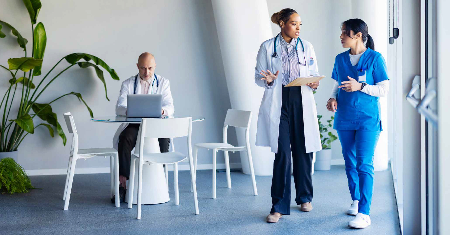 Healthcare professionals walking through a hospital corridor, representing secure clinical collaboration and mobility.
