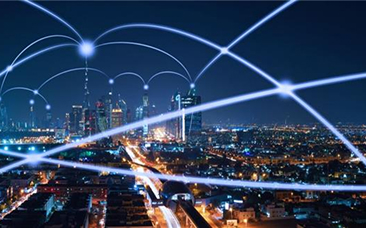 Nighttime city skyline with glowing network lines arcing across the sky, symbolizing digital connectivity over urban streets.