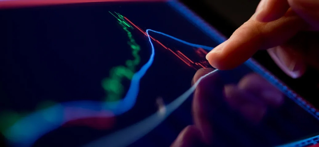 Person interacting with a digital financial data visualization on a touchscreen.
