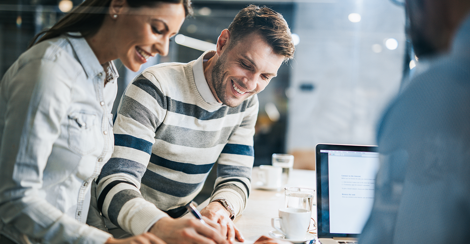 Insurance professionals reviewing documents during a customer consultation.